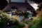 thatched cottage surrounded by blooming flowers and green foliage