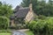 Thatched cottage in the village of Stanton, Cotswolds district of Gloucestershire.  It`s built almost completely of Cotswold stone