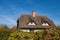 Thatched house with blue sky in Ahrenshoop, Germany