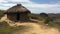 Thatched hut on African meadow, rustic vacation spot generated by AI