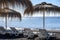 Thatched parasols on black voulcatic lava sand beach