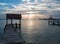 Thatched roof boat dock under sunrise skies in Puerto Juarez harbor