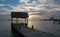 Thatched roof boat dock under sunrise skies in Puerto Juarez harbor