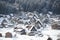 Thatched roof houses covered in snow