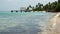 Thatched roofed jetty of Pigeon Point Beach in the Caribean sea on Tobago