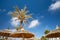 Thatched sunshades and palm trees