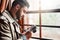 Thats a great shot. a handsome young man standing by a window at home looking at his camera.