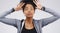 Thats a hair raising story. Studio shot of a young woman making a funny face against a gray background.