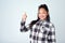 Thats what Im talking about. Studio portrait of a cute young girl giving thumbs up against a gray background.