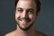 Thats a winning smile. Cropped portrait of a handsome young man against a grey background.