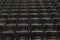 Theater auditorium with emphasis on the black chairs and wooden sides