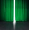 Theater green curtain slightly open with bright light behind and wood stage or scene
