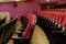 Theater hall for visitors with beautiful chairs of Burgundy-red velvet chairs before the show