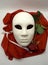 Theater or romance concept. Closeup of white classical theatrical mask and red rose as a symbol of sexual freedom