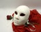 Theater or romance concept. Closeup of white classical theatrical mask and red rose as a symbol of sexual freedom