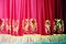 Theatrical red velvet curtain with gold pattern background