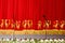 Theatrical red velvet curtain with gold pattern, and the microphones