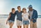 Their favorite memories were made on the beach. a group of happy young friends posing on the beach together.