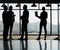 On their way to the top. Silhouette shot of four businesspeople standing in front of their office window.