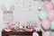 Thematic decoration for parties; Baby Shower - Table decorated with: Cakes, sweets, paper rabbits, and balloons