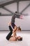 The theme of Acroyoga and Yoga Poses. Acroyogis practicing. with studio Backlight. the man Base holds in the Static poses a woman