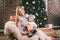 Theme Christmas holidays winter new year. A young stylish Caucasian mother holds her son in her arms for 1 year in a funny shirt