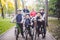 Theme family sports vacation in park in nature. big friendly Caucasian family of six people mountain bike riding in