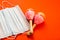 The theme of the holiday is in quarantine. Close-up of maracas and a medical protective mask on a bright orange background. Shallo