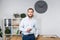 Theme office business. Handsome young caucasian man confident and strong with beard standing in bright room on working place. dres