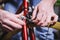 Theme repair bikes. Close-up of a Caucasian man`s hand use a hand tool hexagon set to adjust and install Rim Brakes on a red bicy