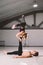 Theme sport and a healthy lifestyle. Acrobatics and acroyoga. Young sporty couple practicing acroyoga handstand. Male and female