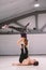 Theme sport and a healthy lifestyle. Acrobatics and acroyoga. Young sporty couple practicing acroyoga handstand. Male and female