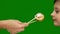 Theme of sushi restaurant. Close-up of a funny preschooler child reaches for sushi, which a female hand holds on chopsticks. The c