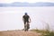 Theme tourism and cycling on mountain biking. guy rides uphill on a rocky, rocky road against the background of the Mediterranean