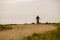 Theme tourism and cycling on mountain biking. guy rides uphill on a rocky, rocky road against the background of the Mediterranean