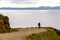 Theme tourism and cycling on mountain biking. guy rides uphill on a rocky, rocky road against the background of the Mediterranean