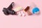 Therapeutic percussive massage gun, fit meal, pills, sport energy bar on pink background - concept of modern sport activity and