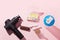 Therapeutic percussive massage gun, fit meal, pills, sport energy bar on pink background - concept of modern sport activity and