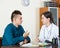 Therapeutist receiving teenage patient in clinic