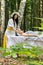 Therapist female doctor making woman relaxing spa face massage with hands outdoors in the forest