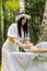 Therapist female doctor making woman relaxing spa face massage with hands outdoors in the forest