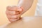 Therapist giving acupuncture treatment to woman in spa