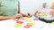 Therapist helping teenage girl with learning difficulties during child therapy. Top view hand detail of a therapist with patient.