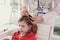 Therapist looks for insects in hair of little patient