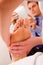 Therapist massaging businessman\'s foot