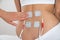 Therapist placing electrodes on woman\'s back