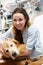 Therapy Dog Visiting Young Female Patient In Hospital