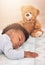 Is there anything more adorable than a sleeping baby. a little baby boy sleeping on a bed with a teddy bear.