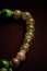 There is a beautiful bead necklace made of retro jade on the red table