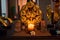 There is a candle on the table, on the sides of the candle are two statuettes of the Buddha